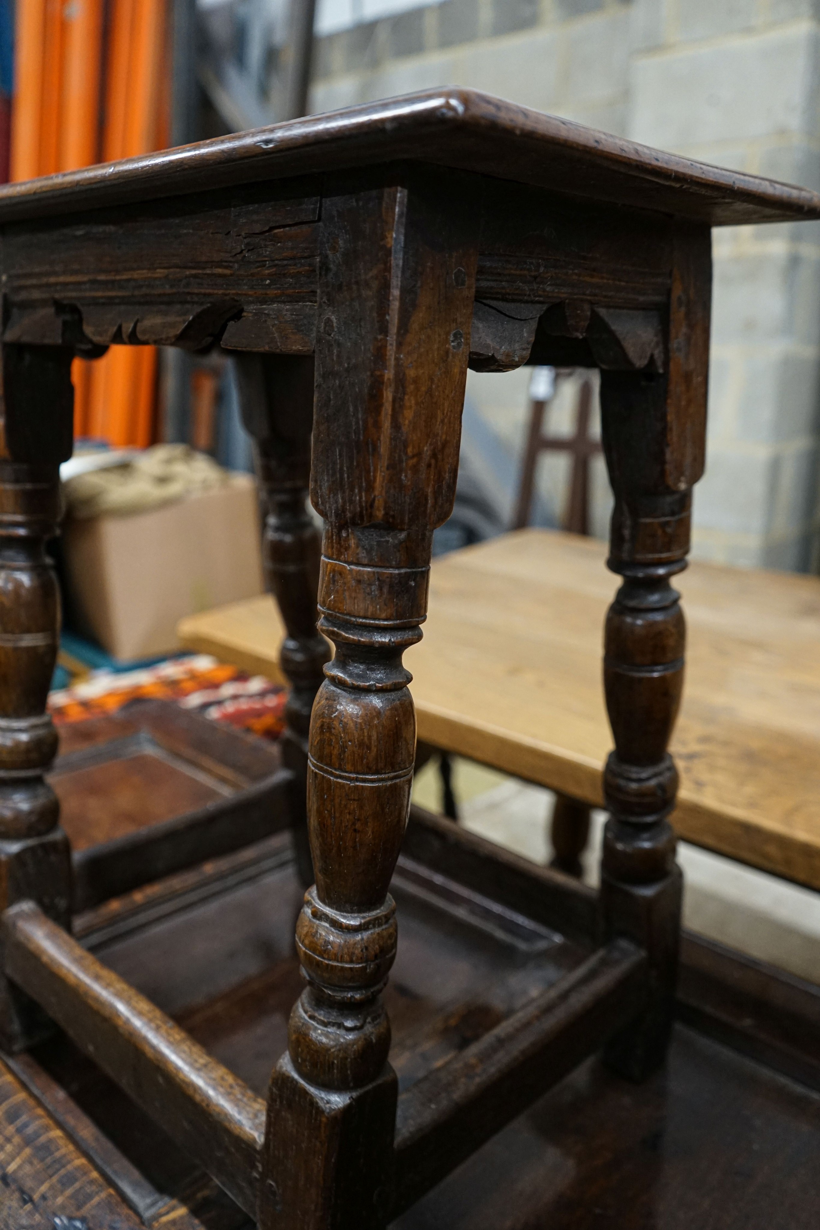 A 17th century style oak joint stool, with turned legs and carved apron, width 46cm, depth 27cm, height 56cm